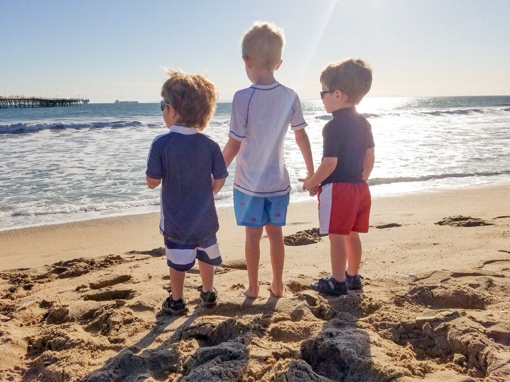 Kids on a SoCal beach looking at the water